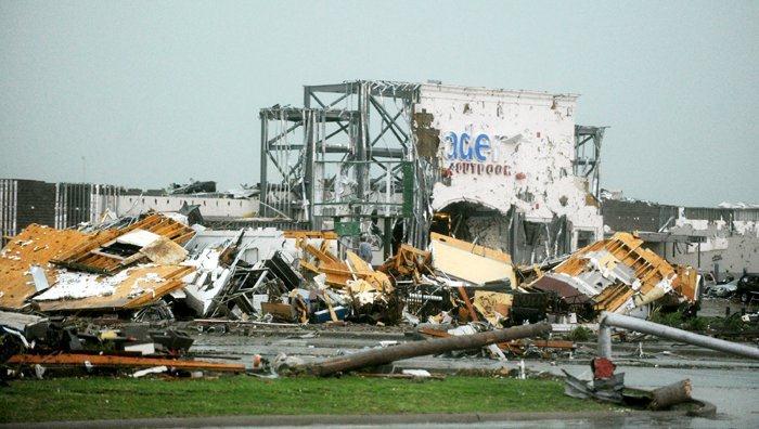 Entire building stripped down to its frame, surrounded by debris.